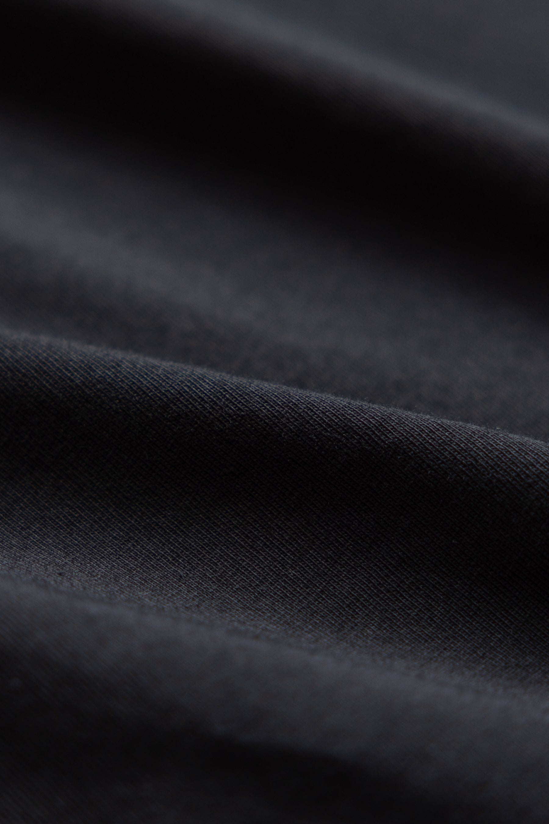 Close-up image of black organic cotton tshirt fabric
