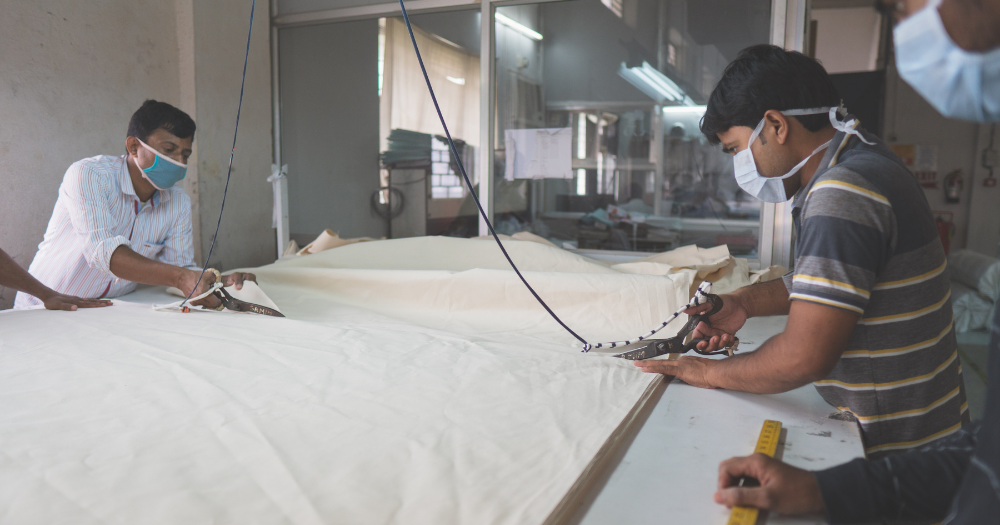 Fairtrade factory worker cutting the fabric