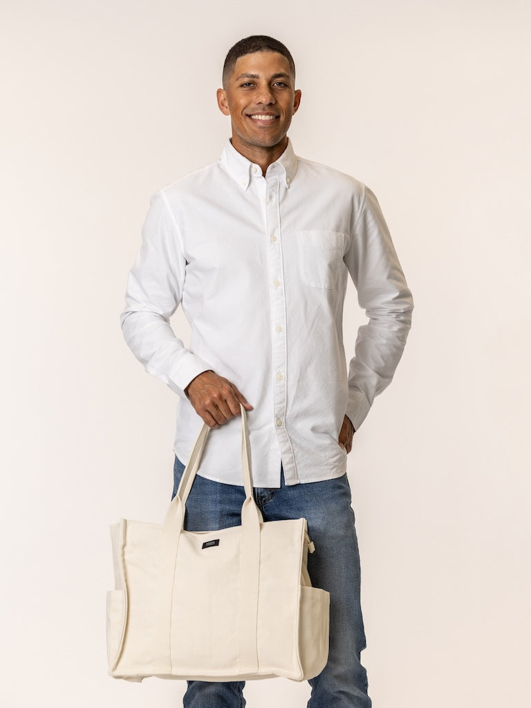 Man holding an everyday tote bag