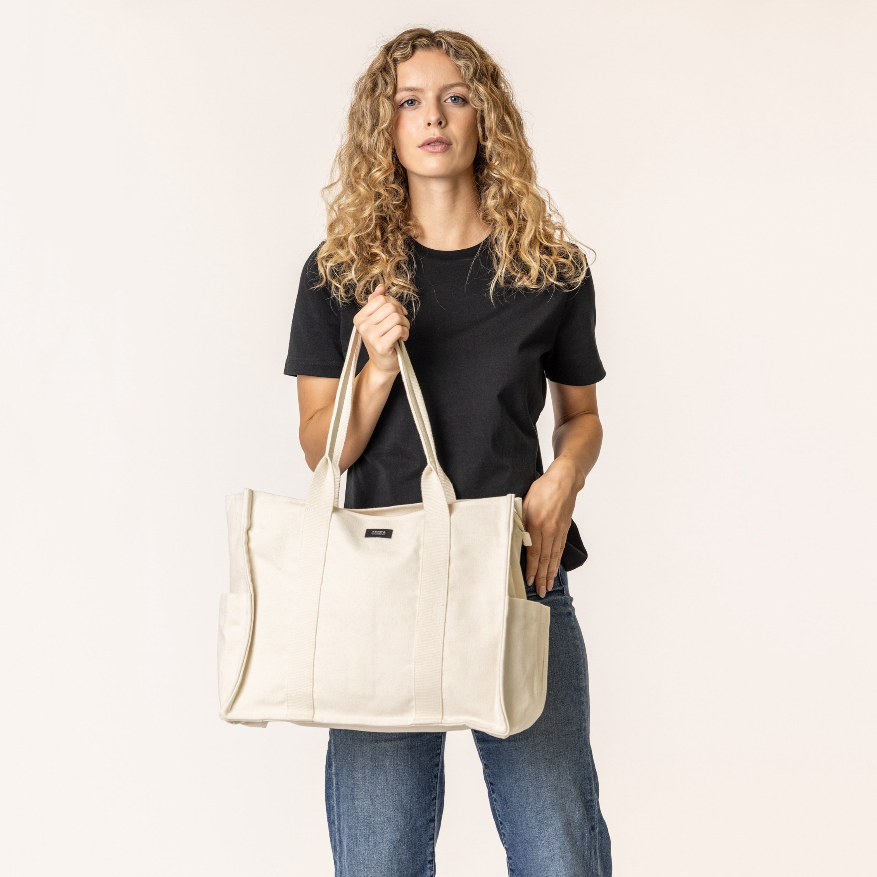 Woman holding a everyday essential canvas handbag