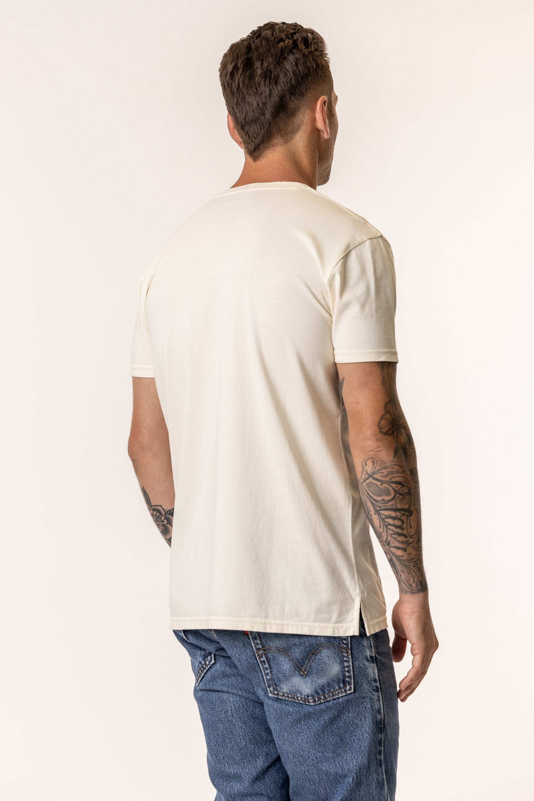 back view of a man wearing mens organic cotton tshirt in natural color