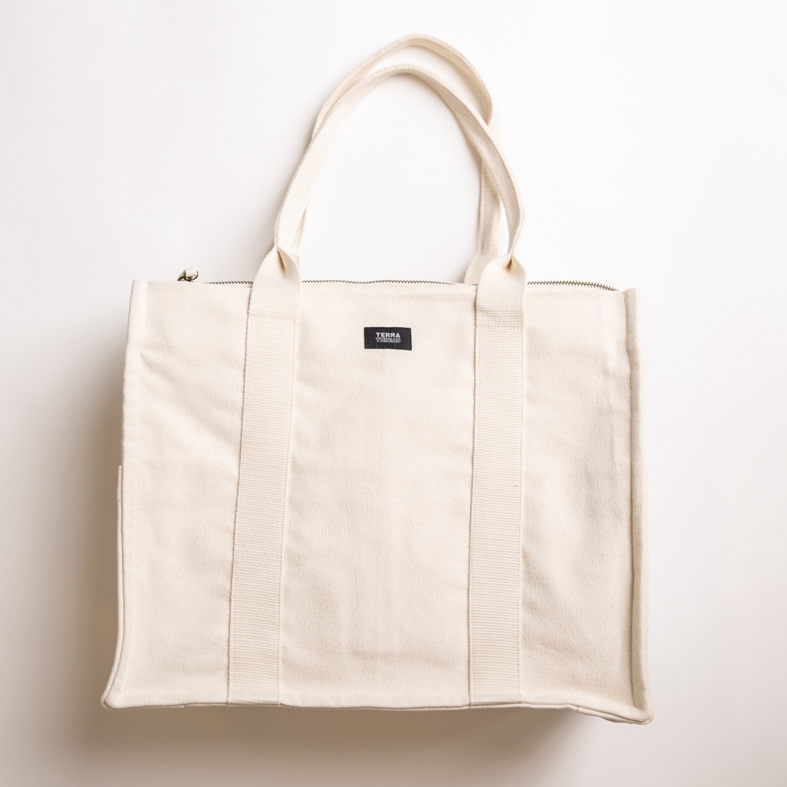 Front view of Terra Thread boxy canvas tote handbag in natural color