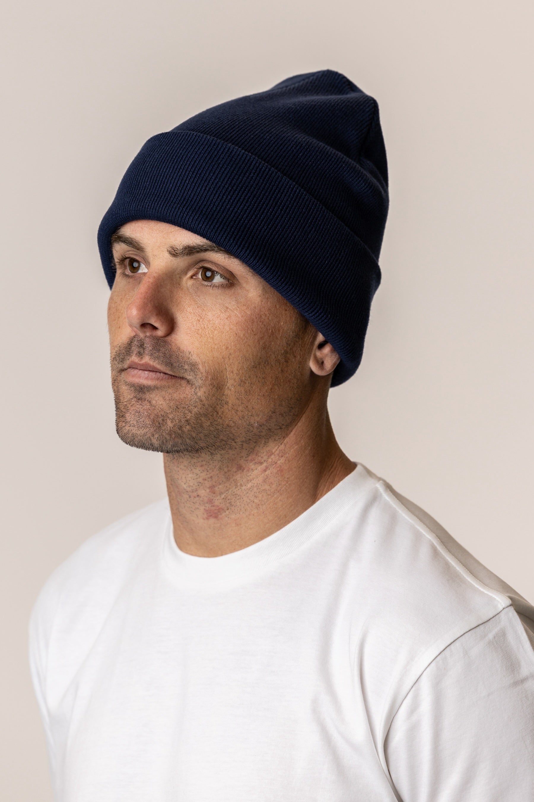 Man wearing a navy blue beanie hat