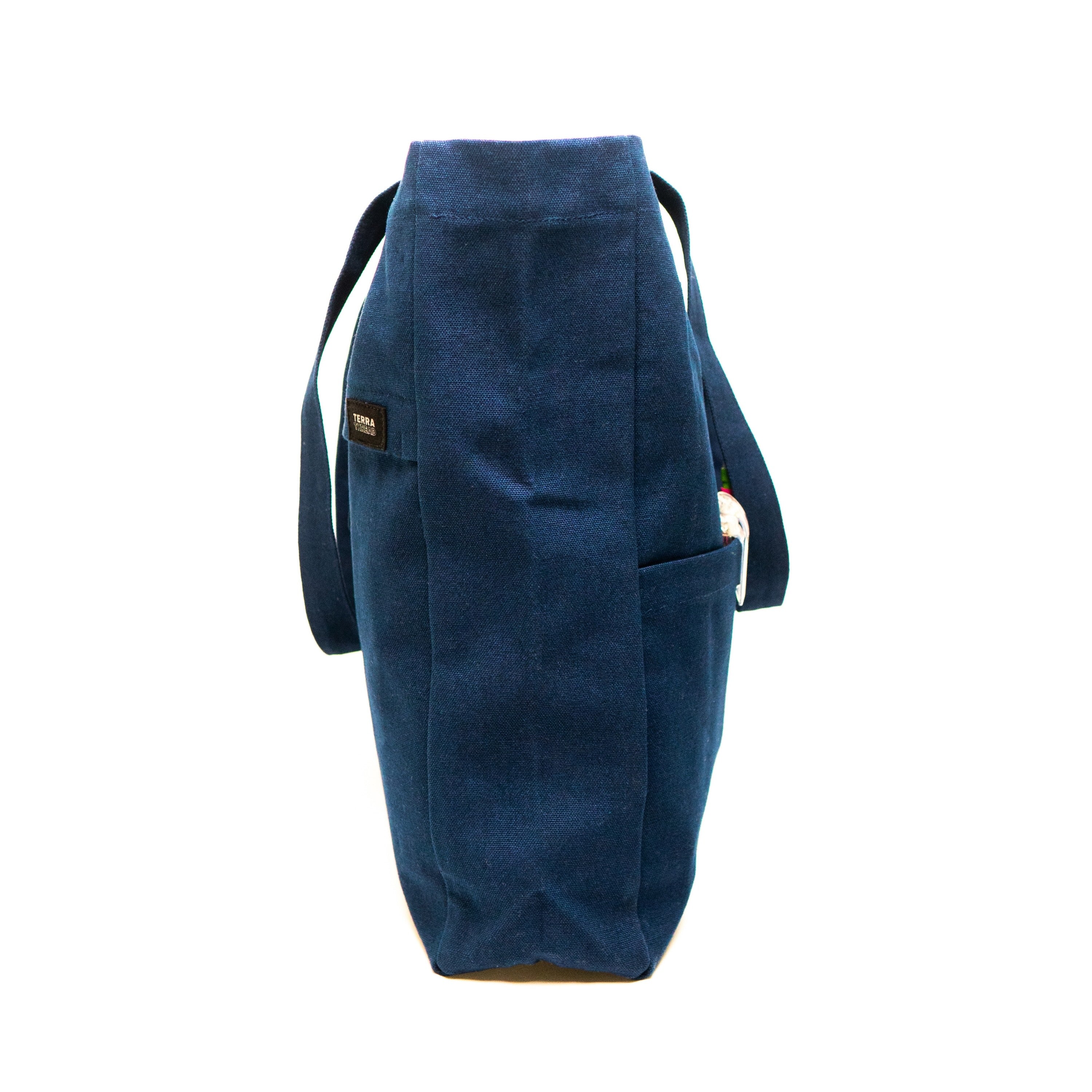 side view of Terra Thread canvas tote bag in navy blue