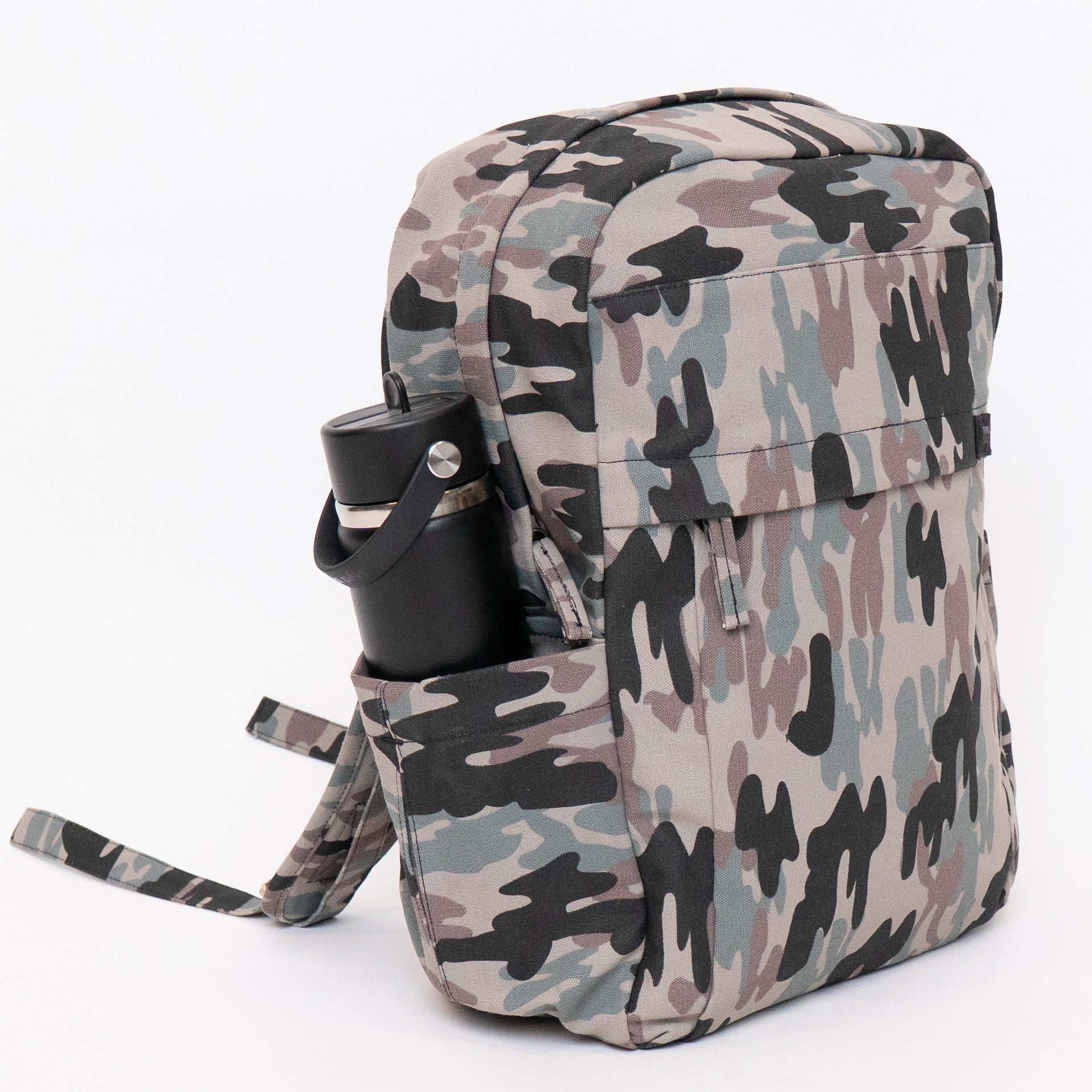 A backpack with a classic camouflage pattern in beige, gray, green, and black, featuring a side pocket holding a black water bottle