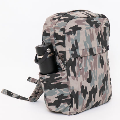 A backpack with a classic camouflage pattern in beige, gray, green, and black, featuring a side pocket holding a black water bottle