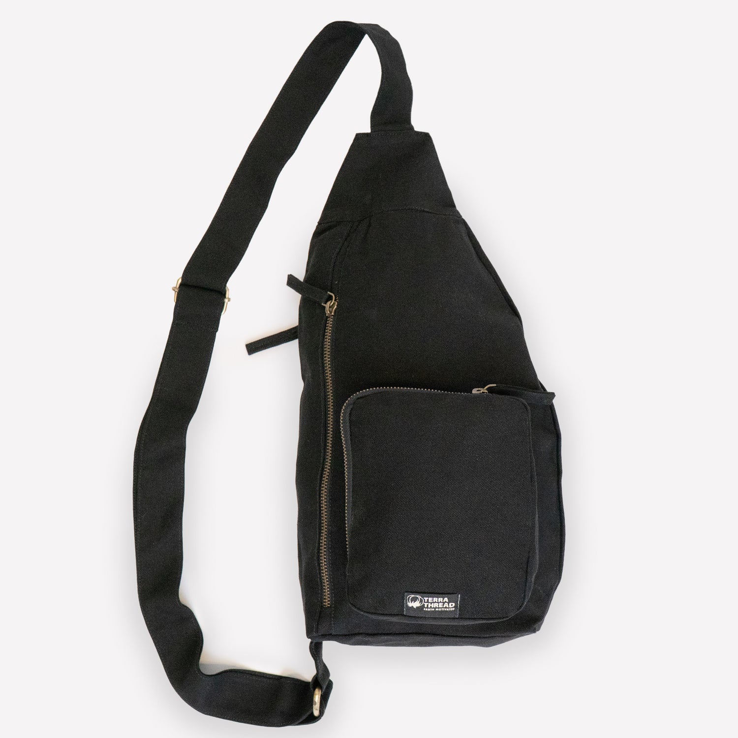 A black canvas sling bag with a wide adjustable shoulder strap and front pockets