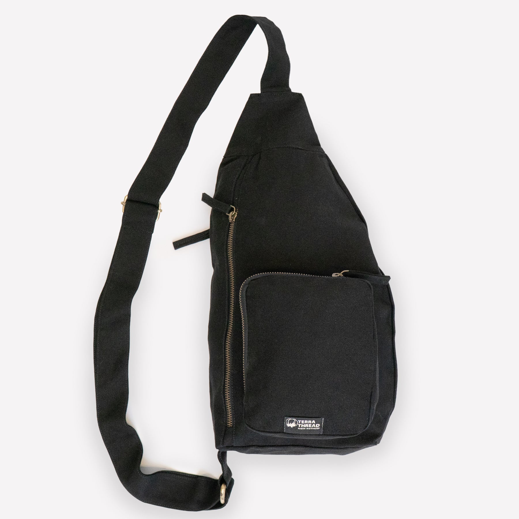 A black canvas sling bag with a wide adjustable shoulder strap and front pockets