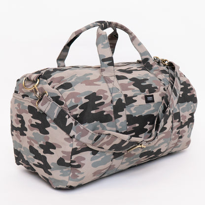 A duffel bag with a classic camouflage pattern in shades of beige, gray, black, and muted green, featuring dual top handles and a shoulder strap, set against a plain white background