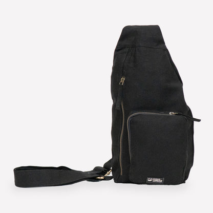 A black canvas sling bag made with organic cotton